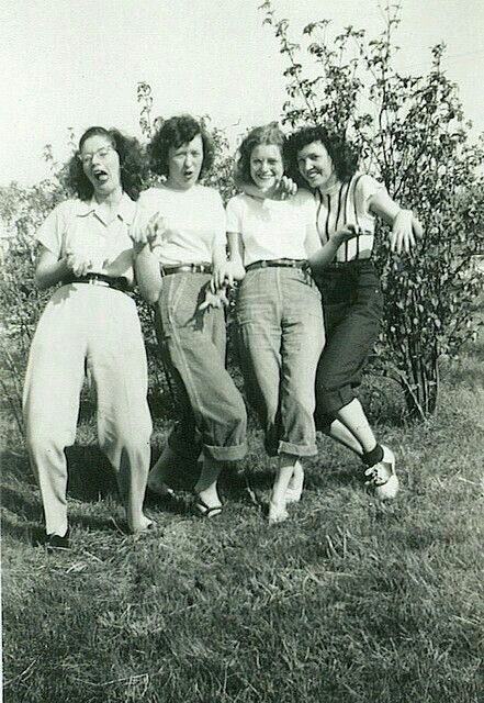 Vintage photo: four young women laughing together outdoors