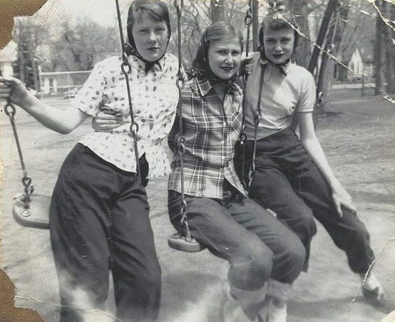 Vintage family photo: three girls together on a swing set