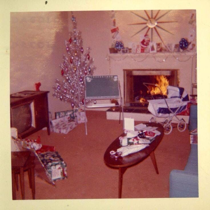 Vintage photo: a mid-century front room with an aluminum Christmas tree and fireplace